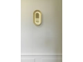 nuura-sasi-small-brass-wall-lamp-mirror-reflections.jpg